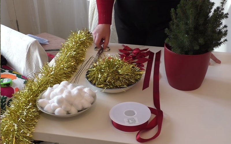 Decorating a Christmas tree for the table