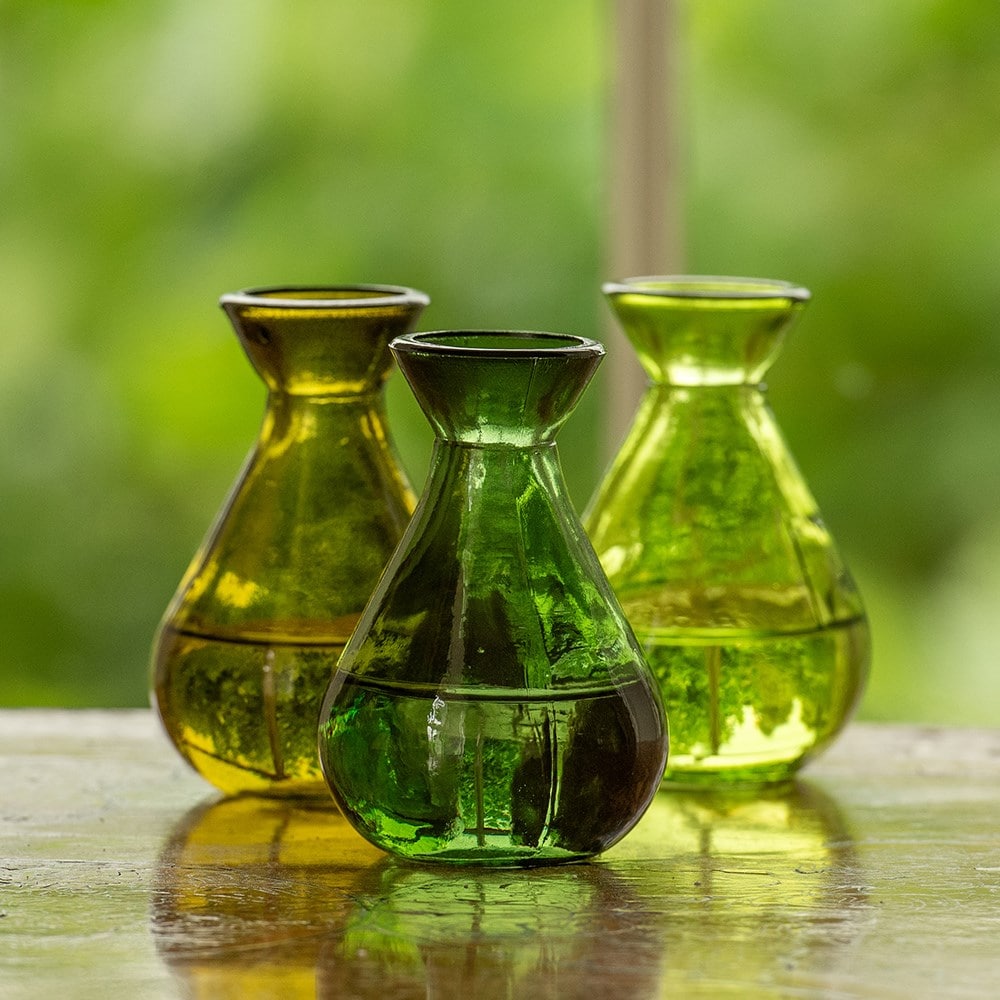 Three green glass bud vases