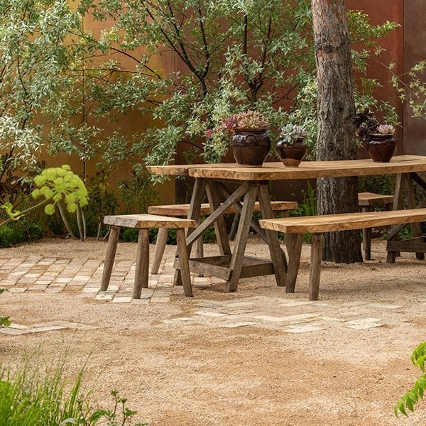 Wooden seating creates an opportunity to contemplate the garden from underneath the Pinus sylvestris.