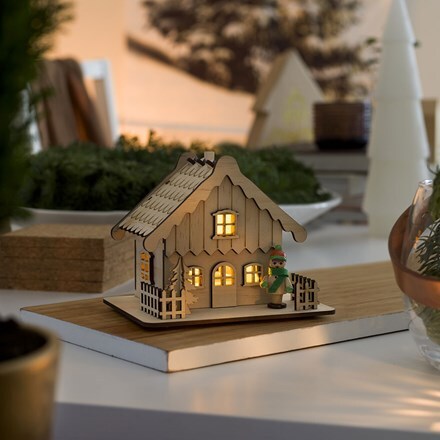 Wooden house silhouette with LEDs