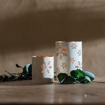 Two metal snowflake design candle holders