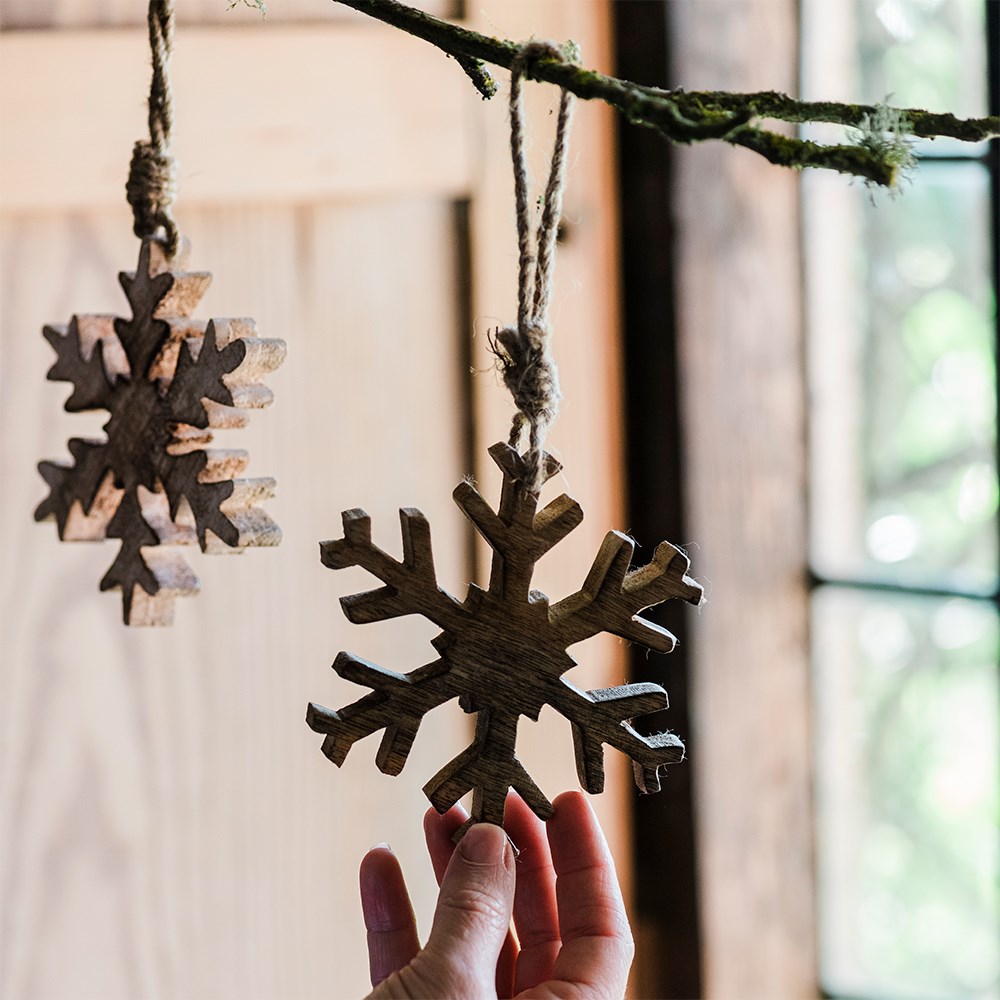 Two wooden snowflake decorations