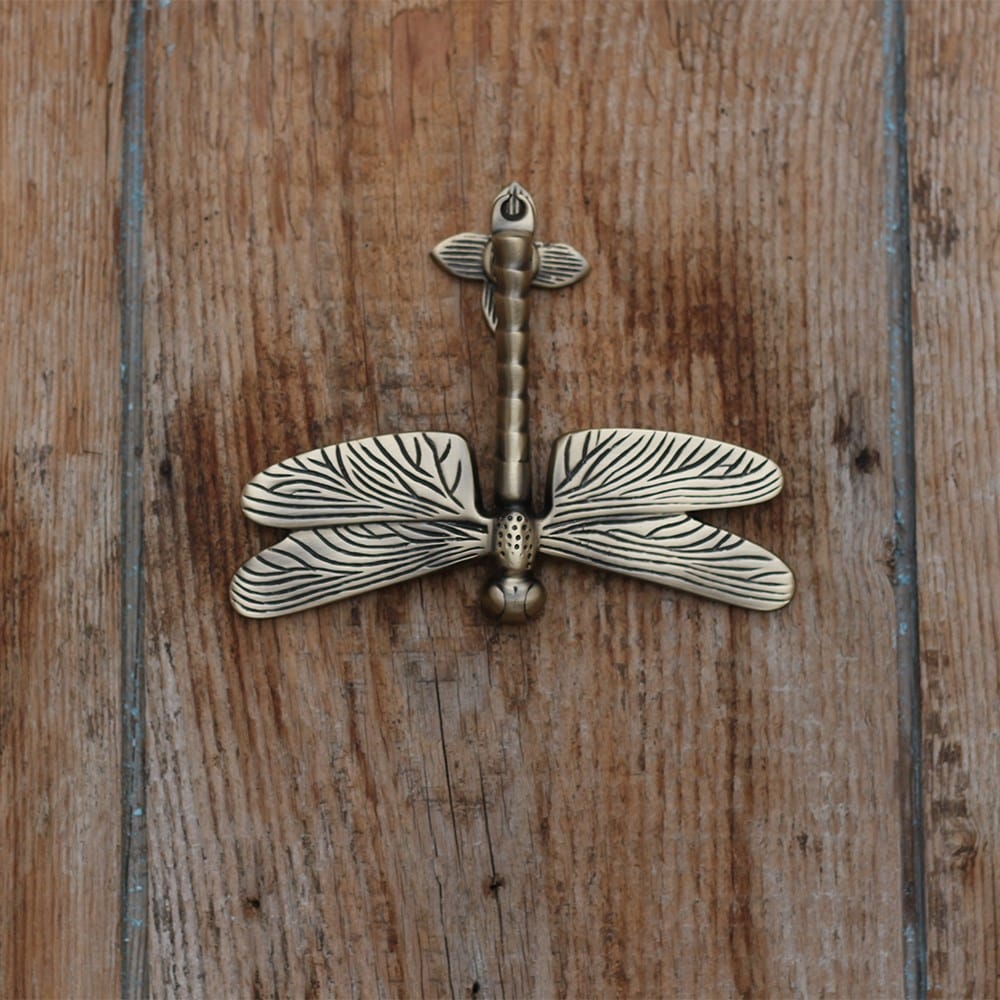 Aged brass dragonfly door knocker