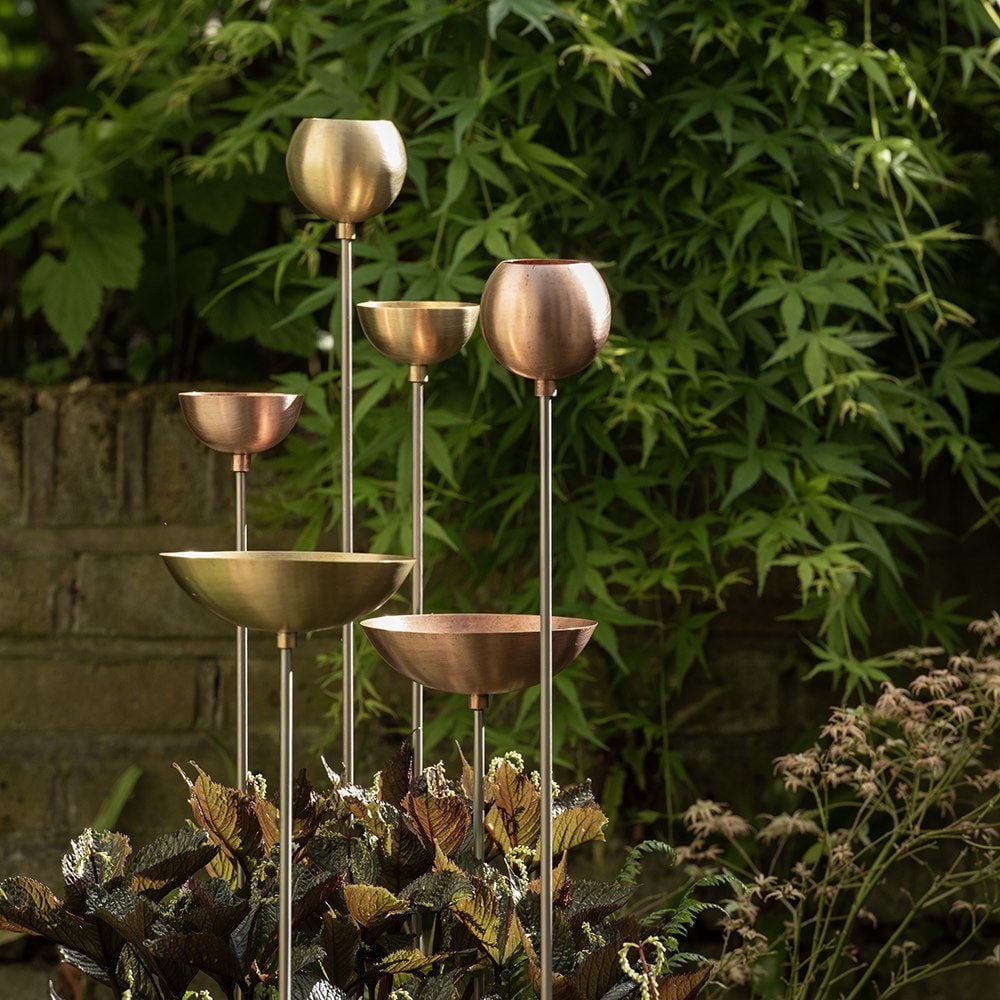Brass bowl on stainless steel stake