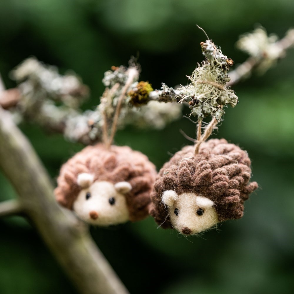 Two hanging felt hedgehogs