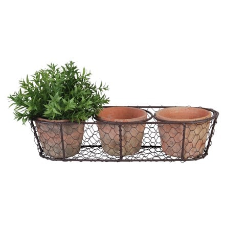 Set of three terracotta pots in basket