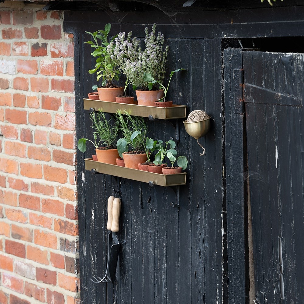 Brushed brass tray with wall brackets