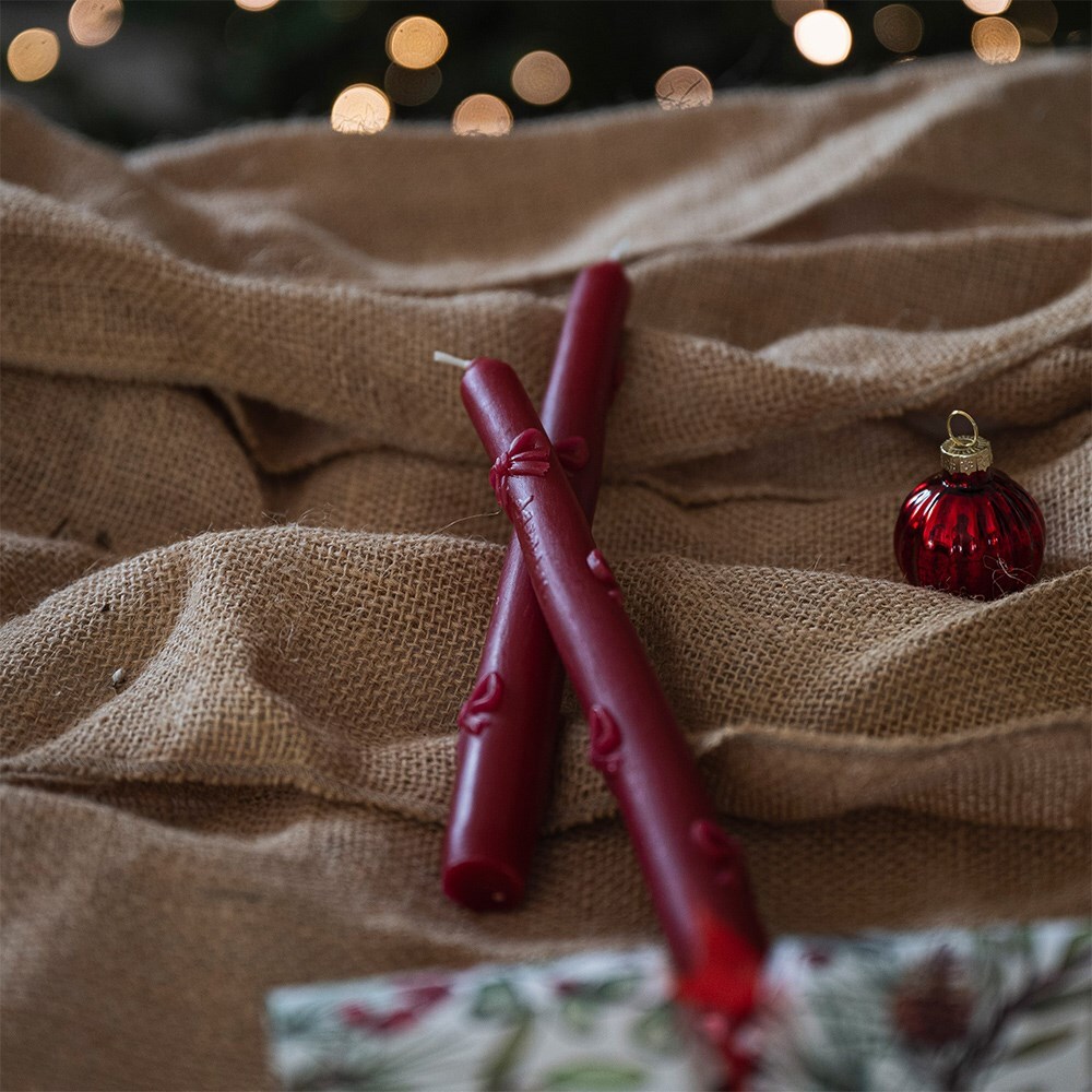 Two red bow dinner candles
